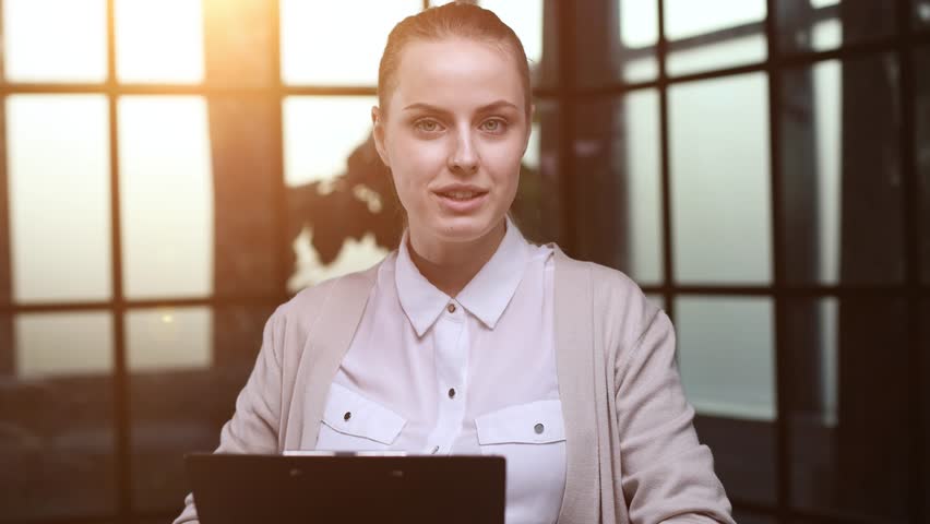 Portrait of a beautiful confident young woman holding a black folder in her hands Royalty-Free Stock Footage #1109045273