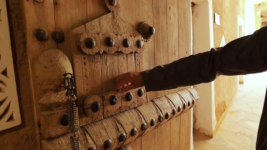 Old wooden door in Jeddah Saudi Arabia. Man's hand touching the door surface Royalty-Free Stock Footage #1109046769