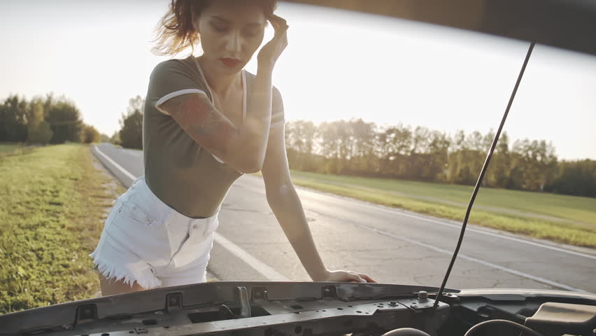 Frustrated lonely woman on country road standing next to broken down car with bonnet up and look sadly. Misfortune, trouble on road concept. Repair of automobile transport. Need to help. Breakdown Royalty-Free Stock Footage #1109048377