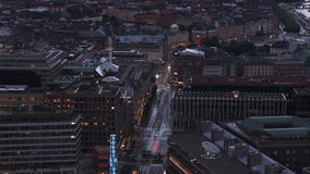 Aerial cinematic footage of multistorey buildings in urban borough at dusk. Commercial buildings. Stockholm, Sweden