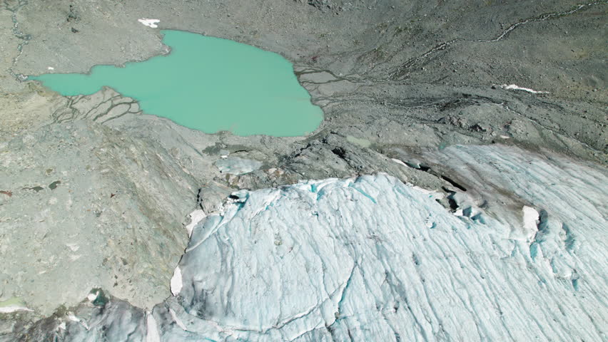 Aerial of Melting Glacier into Mountain Lake in North America