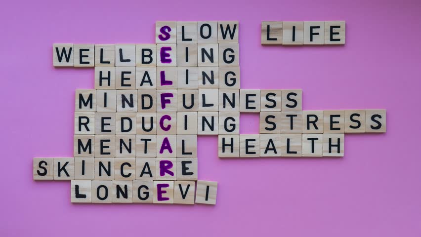TIME LAPSE of Top view of SELFCARE word on pink background. Minimalism creative crossword puzzle concept. Message of text Slow life wellbeing healing mindfulness reducing stress mental health skincare