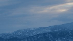 Mountain Range With Clouds Drifting In Foreground. View Mountain With Clouds. Timelapse. - Powered by Shutterstock - Get 15% off with code: PIKWIZARD15
