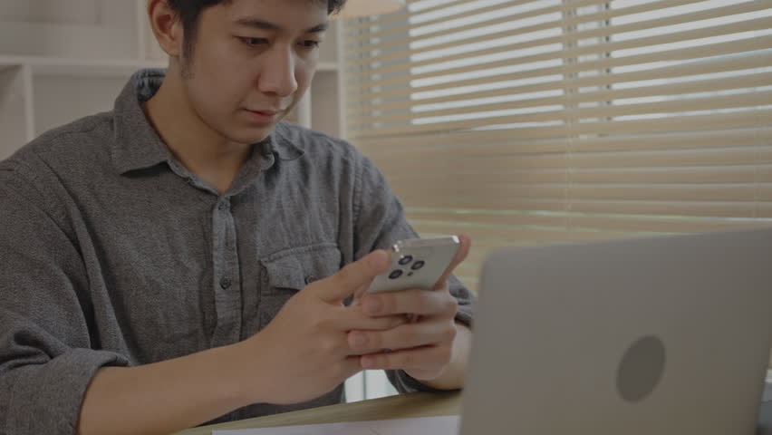 Young man typing chat or message on mobile phone with smiling face, Digital Communication, Conversation via smartphone of internet network. | Shutterstock HD Video #1109059105
