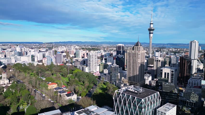 Auckland, New Zealand: Aerial drone footage of Auckland downtown district skyline and the Albert park in New Zealand largest city, shot with a rotation motion.  Royalty-Free Stock Footage #1109061535