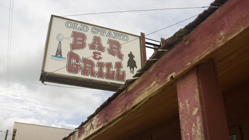 Wild West Bar And Grill Sign On Building.