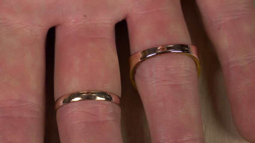 scientist applies a reagent to two rings and finds out which one is fake and not gold.