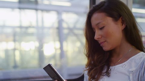 4K Attractive woman engrossed in her phone on her train journey in slow motion, shot on RED EPIC