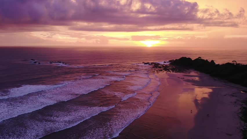 Intense sunset over Playa Guiones, vast seascape. Nosara, Costa Rica