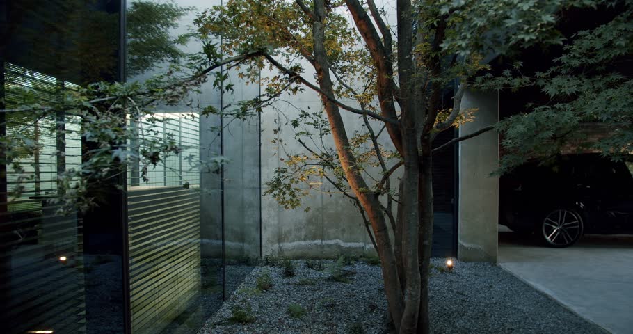 Car parking near modern residential house with glass wall. Covered place for storage auto