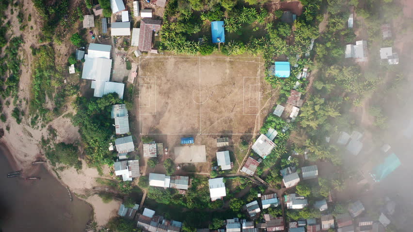 Longneck karen village in the mountain with football pitch or soccer field. Mae Hong Son, Thailand. Aerial Shot Royalty-Free Stock Footage #1109074667
