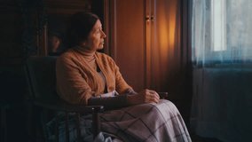 Pensive senior woman sitting alone in armchair covered with blanket, loneliness - Powered by Shutterstock - Get 15% off with code: PIKWIZARD15