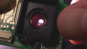 camera and microcircuit matrix with chips and transistors close-up