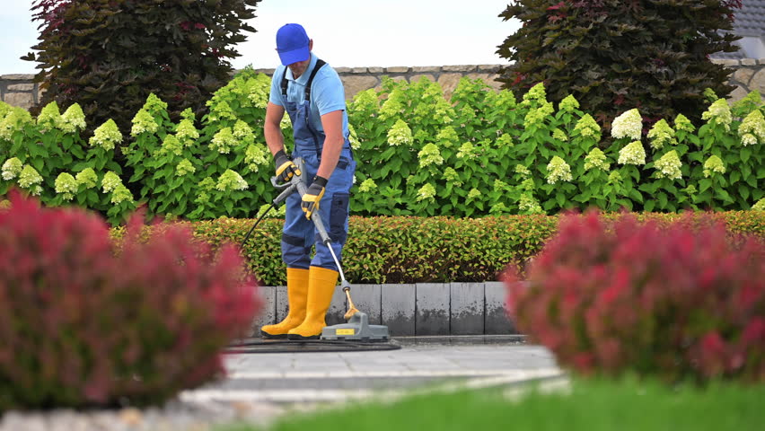 Worker Pressure Washing Residential Driveway Using Modern Pressure Washer Royalty-Free Stock Footage #1109085745
