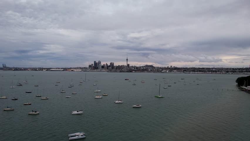 Aerial Footage Over the Waitemata Harbour with the City Skyline of Auckland in New Zealand with Yachts in the Foreground.