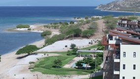 Beachfront residence apartments with swimming pool at Puntarena, Bani in Dominican Republic. Aerial lateral