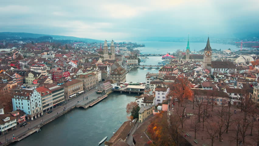 Aerial drone footage of Zurich old town and downtown along the Limmat river and lake Zurich in Switzerland largest city