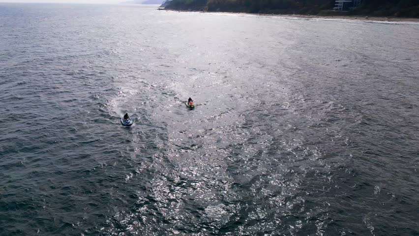 Aerial view of a personal watercraft speeding through the waves, creating a mesmerizing trail. Royalty-Free Stock Footage #1109098199
