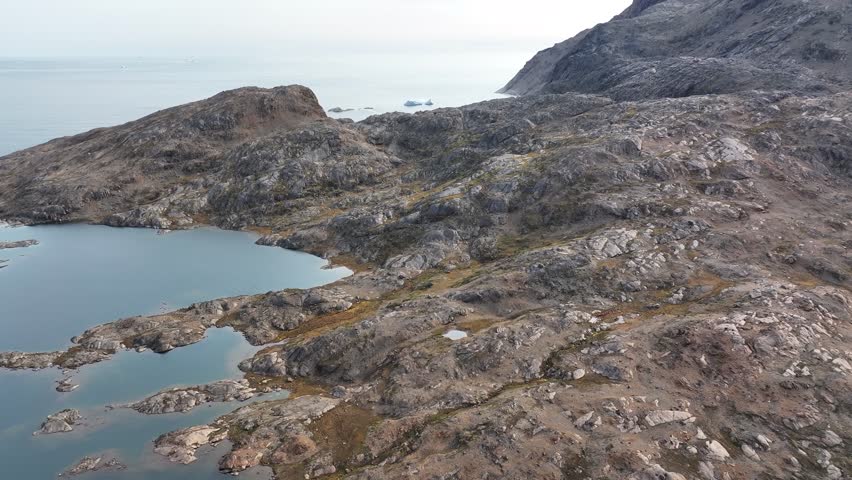 aerial view of mountains and lake in Greenland
