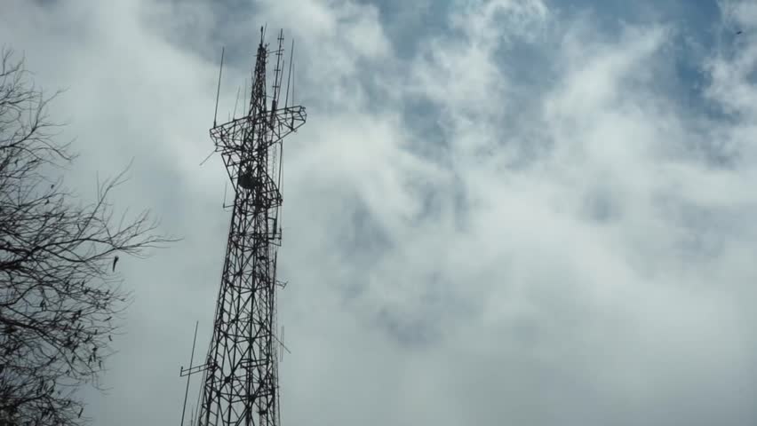 Timelapse footage of a signal tower with moving clouds in the background. | Shutterstock HD Video #1109102079