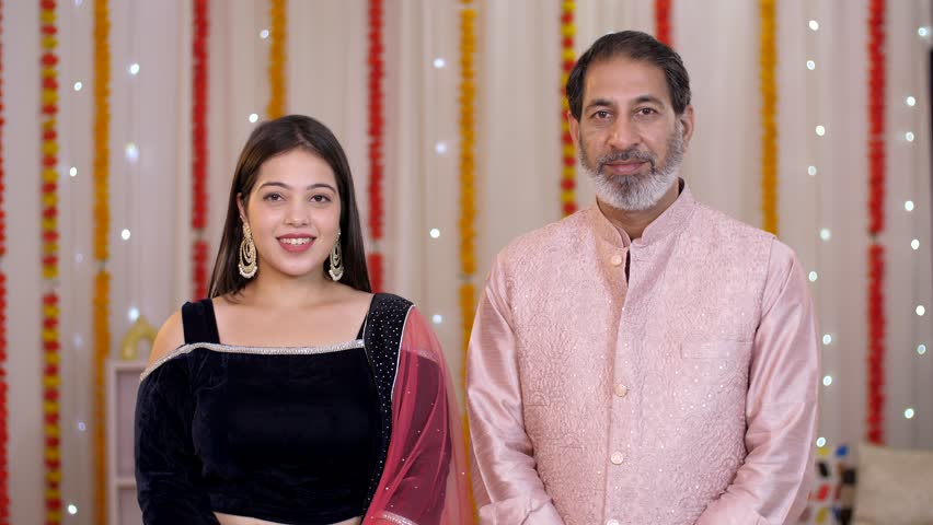 Father and daughter greeting people on Diwali - Indian culture, Namaste gesture, Diwali celebrations. An Indian man and young female in ethnic wear during the Diwali celebration—happy Indian family...