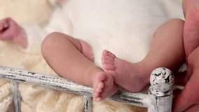 Sleeping newborn cute baby girl or boy during first week of life. 4k slow motion raw video. Breakfast concept. Small baby sleep in white vintage bed in white rabbit costume with breakfast on table