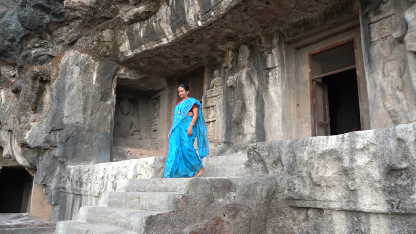 Woman tourist explore the Ellora caves, It is one of the largest rock-cut cave complexes in the world and UNESCO world heritage