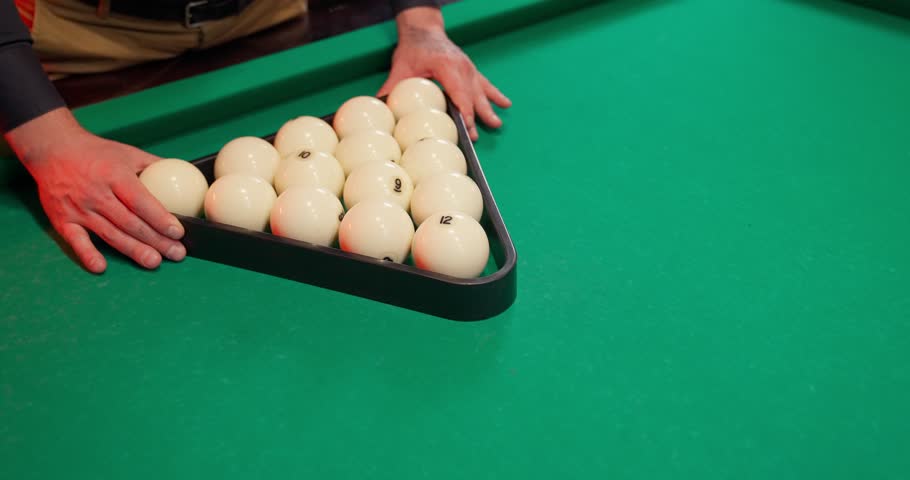 A young man plays American billiards. Russian billiards, an American in a billiards club and bar. Dark colors in the billiard club. A man pockets snooker balls. | Shutterstock HD Video #1109109857