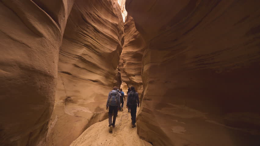 Deep sandstone canyons in Jordan, akin to other remarkable canyons like Antelope Canyon or the Grand Canyon in the USA. These natural wonders showcase intricate patterns and vibrant hues as sunlight f Royalty-Free Stock Footage #1109112655