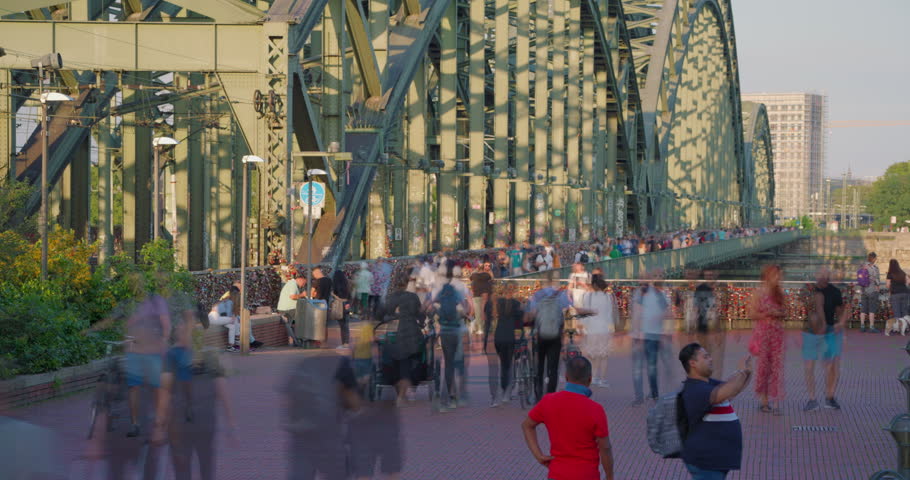 Crowd of tourist people walk on Hohenzollern bridge in Cologne, Germany. Timelapse