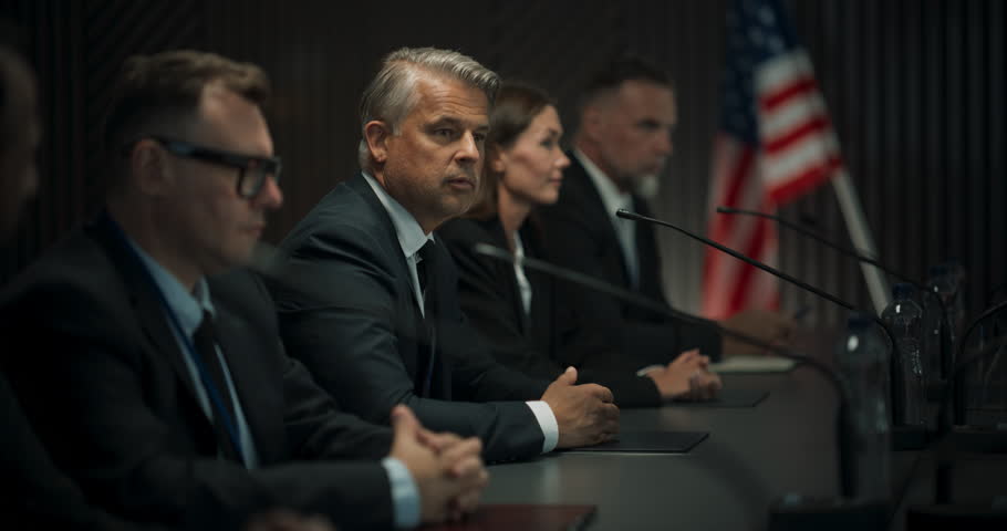 Caucasian Male Organization Representative Speaking at Conference in Government Building. Head Of USA Delegation Delivering a Speech at an International Political Summit. Diverse Delegates Listening. Royalty-Free Stock Footage #1109116029