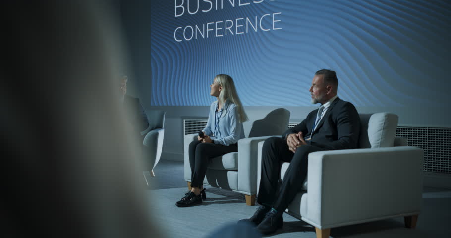 International Business Conference: Host Asking Caucasian Female Tech CEO a Question In Front Of Audience Of Diverse Attendees. Successful Woman Delivering Inspirational Speech For Women In Leadership. Royalty-Free Stock Footage #1109116031