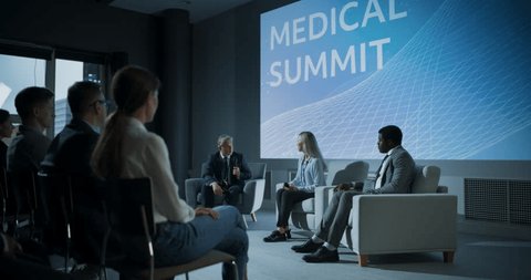 International Medical Summit: Host Asking Caucasian Female Pharmaceutical CEO a Question In Front Of Audience Of Diverse Attendees. Woman Talking About New Developments In Biotechnology, Medicine.: stockvideo