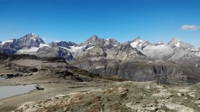 4K drone footage over the Swiss Alps with the majestic Matterhorn on the back, Switzerland.
Mid angle, traveling movement.