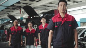 Asian and African  automotive engineer people wear helmet work in mechanics garage.young auto mechanic in uniform is looking at camera and smiling examining car. - Powered by Shutterstock - Get 15% off with code: PIKWIZARD15