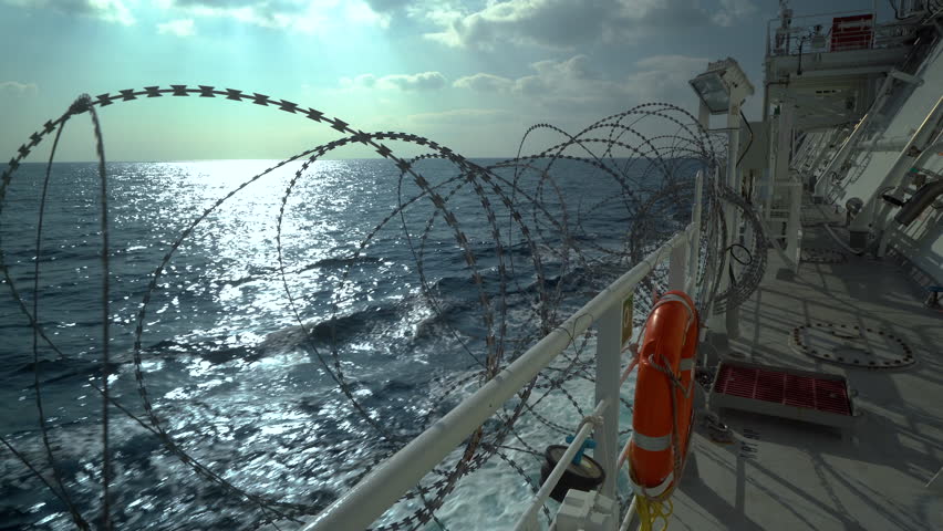 Barbed wire on ship railings. Protection from pirates. Open deck in barbed wire. Pirate high risk area in sea. Royalty-Free Stock Footage #1109129869