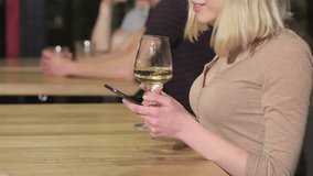 Close up of a young woman drinks wine holding phone in her hand - Powered by Shutterstock - Get 15% off with code: PIKWIZARD15