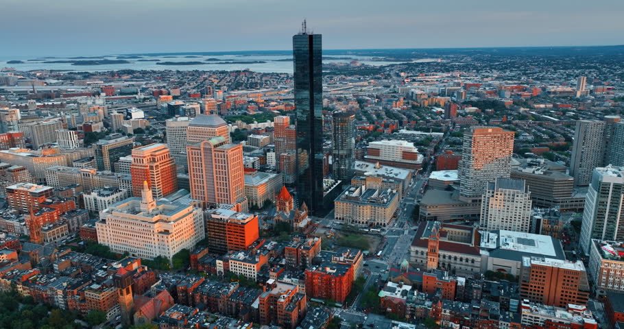 John Hancock Tower standing out in the architectural ensemble of Boston downtown. Stunning scenery of American metropolis after sundown. Top view.