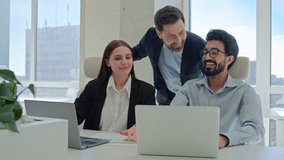 Multiracial happy businessmen and businesswoman business teamwork brainstorm using laptop computer at workplace coworkers group discuss together corporate project software CEO boss help team at office - Powered by Shutterstock - Get 15% off with code: PIKWIZARD15