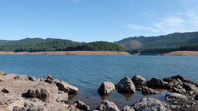 Low water at Fall Creek Reservoir but not because of drought. The state has required low water levels in some reservoirs to help wild salmon make it upstream. HD video clip 1080p 30fps.