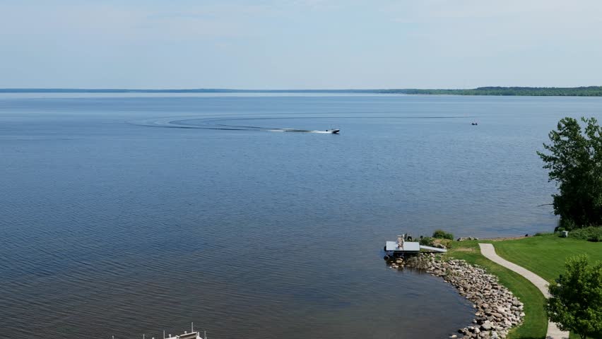 Fishing boats are seen on the beautiful blue water of Lake Bemidji in Minnesotam a popular tourism and vacation destination.