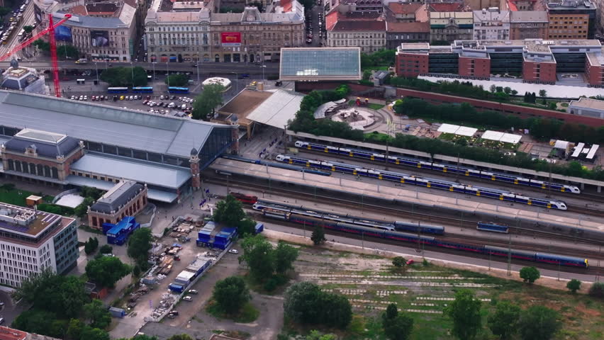 High angle view of passenger trains standing in Nyugati train station. Platforms and historic station buildings from height. Budapest, Hungary