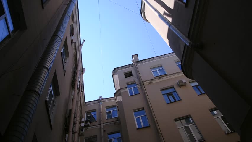 Low angle view of typical well shaped back yard in a sunny summer day in Saint-Petersburg city, Russia. Clear blue sky. Real time handheld video. General architecture theme. | Shutterstock HD Video #1109153687
