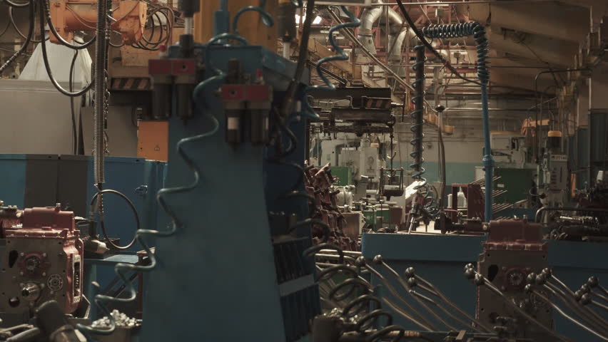 Closed production assembly line without people with pneumatic impact wrenches in factory. Stopped production after evacuation due to danger report. Empty workplaces due to workers strike. Royalty-Free Stock Footage #1109161913