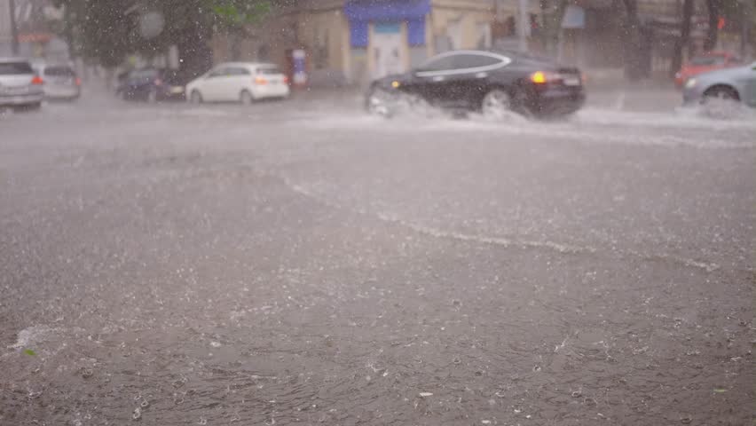 Slow motion, Cars and city transport are driving through crossroads under heavy rain, flood in city Royalty-Free Stock Footage #1109162809