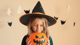 Video portrait happy face girl trick or treat Halloween excited surprise kid girl wearing dress witch hat costume party Halloween isolated studio background Seasonal sale discount shopping children