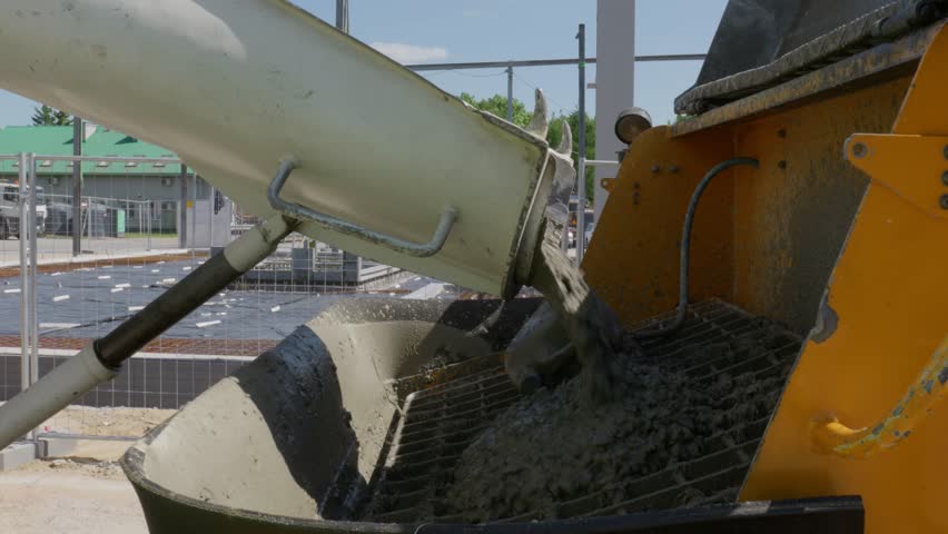 Concrete Mixer Truck Discharging Ready-mix Cement At The Construction Site. - close up Royalty-Free Stock Footage #1109164295