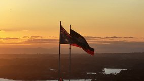 Australian and Aboriginal Flag Flying In the Sunset, Sydney in the Background, Golden Hour, Cinematic, Wide Angle Aerial, Circulating Shot - Powered by Shutterstock - Get 15% off with code: PIKWIZARD15