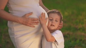 a son pregnant mother. little boy hugs his pregnant mom belly. son pregnant mom happy family kid dream concept.woman experiences motherhood for second time, boy will become lifestyle the older brother - Powered by Shutterstock - Get 15% off with code: PIKWIZARD15
