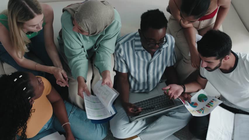 Top view of Fucused female and male students study, preparing for exams. Classmates friends study or work together, doing homework. Multiethnic team, multiracial group of students learn together